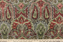 Load image into Gallery viewer, This paisley print design has a distressed look and would be perfect for  window treatments (draperies, valances, curtains and swags), toss pillows, duvet covers, and upholstery projects.  It is soil and stain repellant and has a soft workable feel yet is stable and durable with 27,000 double rubs.  Colors included are red, green, brown and blue.
