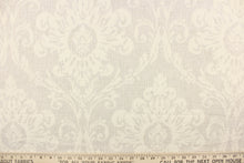 Load image into Gallery viewer,  This jacquard fabric features a woven ornamental damask medallion in natural. 
