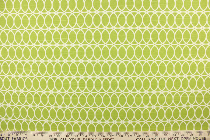 This contemporary design features interlocking white circles set against a lime green background. 