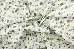 This fabric features a fun geometric design in shades of blue, gray and tan on a off white background.