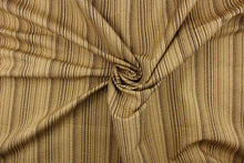 Load image into Gallery viewer, This multi-use fabric features a striped design in shades of brown and gold.  
