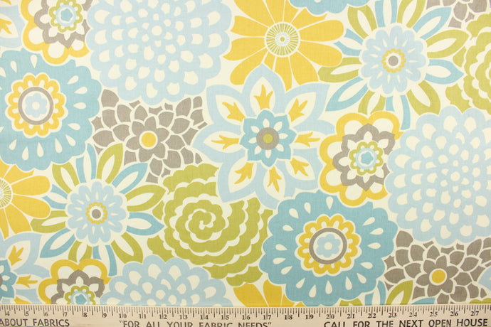 This fabric features a large floral print design in shades of blue, taupe and mustard yellow on an off white background. 