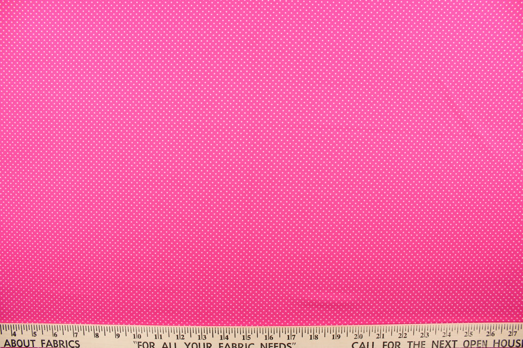 This prints features white polka dots on a pink background. 