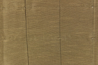 This beautiful jacquard fabric features an pin tuck block design in a  brown green color. 