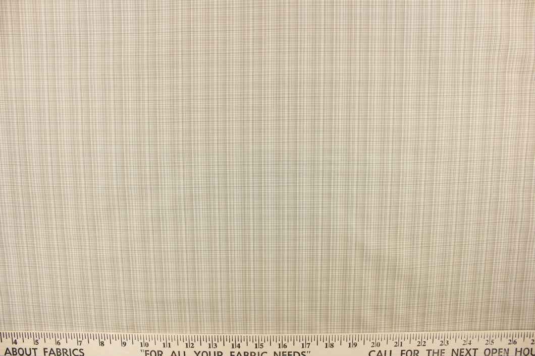 This stunning yarn dyed fabric features a small plaid design in light khaki and beige.