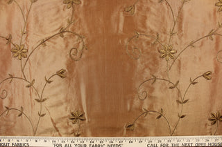 This beautiful fabric features an embroider floral design in a iridescent gold. 