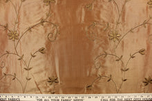 Load image into Gallery viewer, This beautiful fabric features an embroider floral design in a iridescent gold. 
