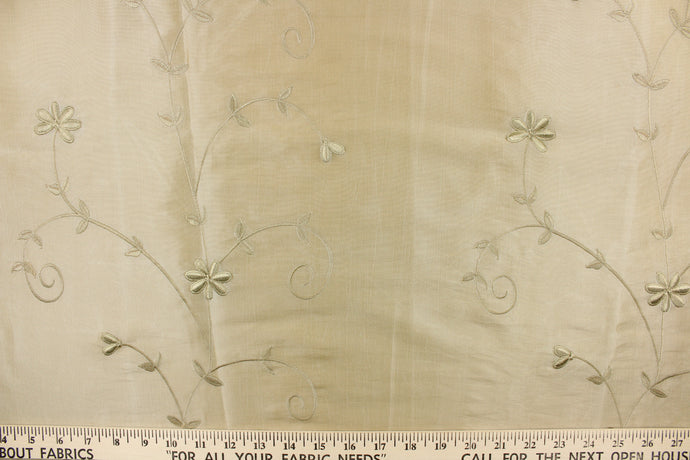  This beautiful jacquard fabric features an embroider floral design in a khaki color. 