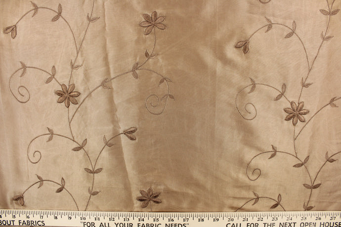  This beautiful jacquard fabric features an embroider floral design in a golden tan.