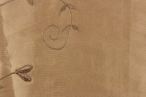  This beautiful jacquard fabric features an embroider floral design in a golden tan.