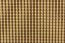 Load image into Gallery viewer,  This yarn dye stripe fabric features a small plaid or checkered design in brown and tan. 
