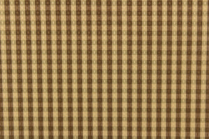  This yarn dye stripe fabric features a small plaid or checkered design in brown and tan. 