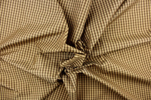 Load image into Gallery viewer,  This yarn dye stripe fabric features a small plaid or checkered design in brown and tan. 
