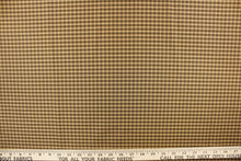 Load image into Gallery viewer,  This yarn dye stripe fabric features a small plaid or checkered design in brown and  dark tan with green undertones
