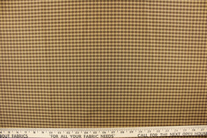  This yarn dye stripe fabric features a small plaid or checkered design in brown and  dark tan with green undertones