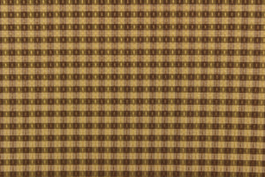  This yarn dye stripe fabric features a small plaid or checkered design in brown and  dark tan with green undertones