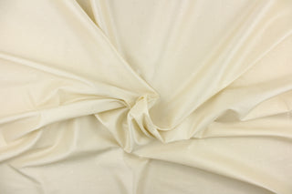 This beautiful jacquard fabric features an embroider pin head design in a beautiful cream color. 