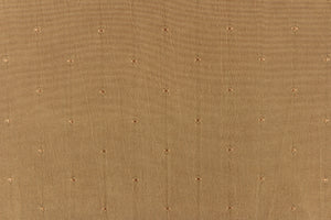 This beautiful jacquard fabric features an embroider pin head design in a rich tan.