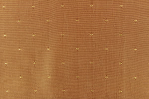 This beautiful jacquard fabric features an embroider pin head design in gold. 