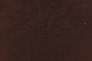 This beautiful jacquard fabric features an embroider pin head design in a rich dark brown. 