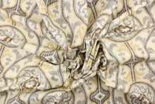 Load image into Gallery viewer, This fabric features a medallion print design that has an aged and distressed look. Colors include slate gray, tan, charcoal and off white.
