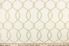Load image into Gallery viewer,  This fabric features a lattice design with overlapping oval shapes in light brown on an ivory background. 
