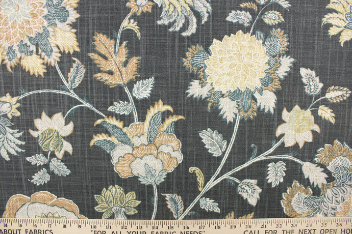 This fabric features a large print floral design on a gray background.  Colors include blue, navy, taupe, silver gold.