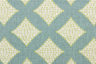 This fabric features diamonds in green and white against a turquoise background.