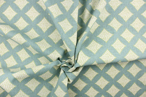 This fabric features diamonds in green and white against a turquoise background.