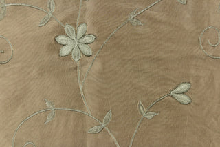 This beautiful jacquard fabric features an embroider floral design in a olive green tone. 