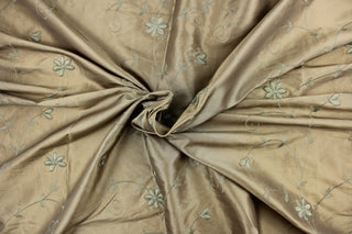 This beautiful jacquard fabric features an embroider floral design in a olive green tone. 