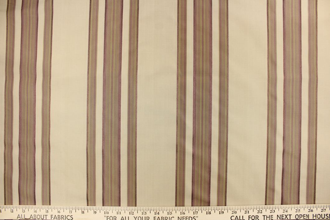 This fabric features a multi width stripe design in khaki, beige and purple.