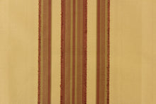 Load image into Gallery viewer,  This fabric features a multi width stripe design in tan and a rich red.
