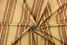 Load image into Gallery viewer,  This fabric features a multi width stripe design in tan and a rich red.
