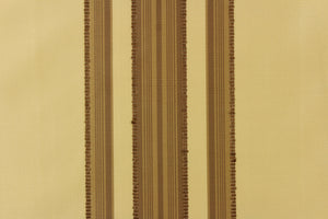 This fabric features a multi width stripe design in beige and dark brown. 