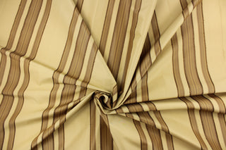This fabric features a multi width stripe design in beige and dark brown. 