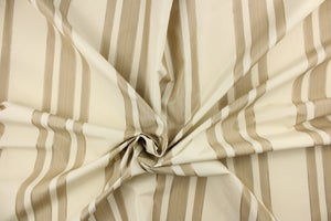 This fabric features a multi width stripe design in off white or light khaki and beige. 