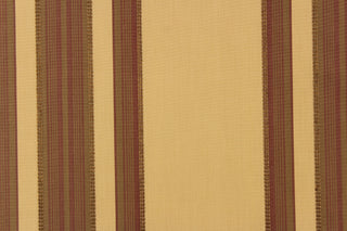  This fabric features a multi width stripe design in tan, brown and burgundy.