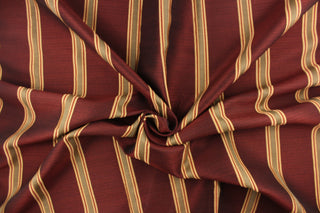 This rich woven yarn dyed fabric features bold multi width striped design in a rich wine red, taupe, and gold. 