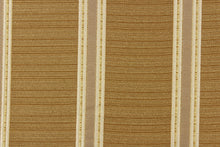 Load image into Gallery viewer, This rich woven yarn dyed fabric features bold multi width striped design gold, beige, and cream. 
