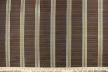 Load image into Gallery viewer, This rich woven yarn dyed fabric features bold multi width striped design in light blue, dark brown and copper. 
