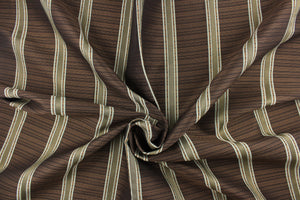 This rich woven yarn dyed fabric features bold multi width striped design in light blue, dark brown and copper. 
