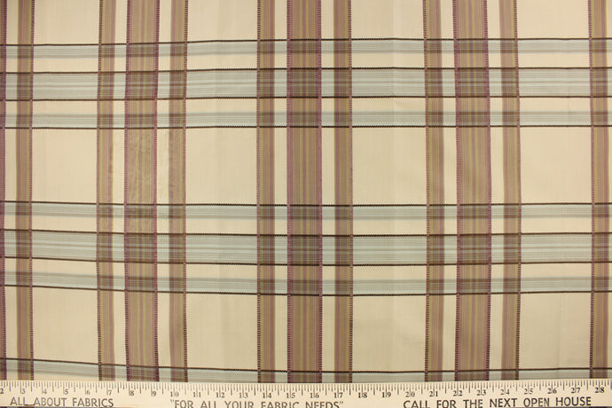This fabric features a plaid design in mauve, pale blue and taupe. 