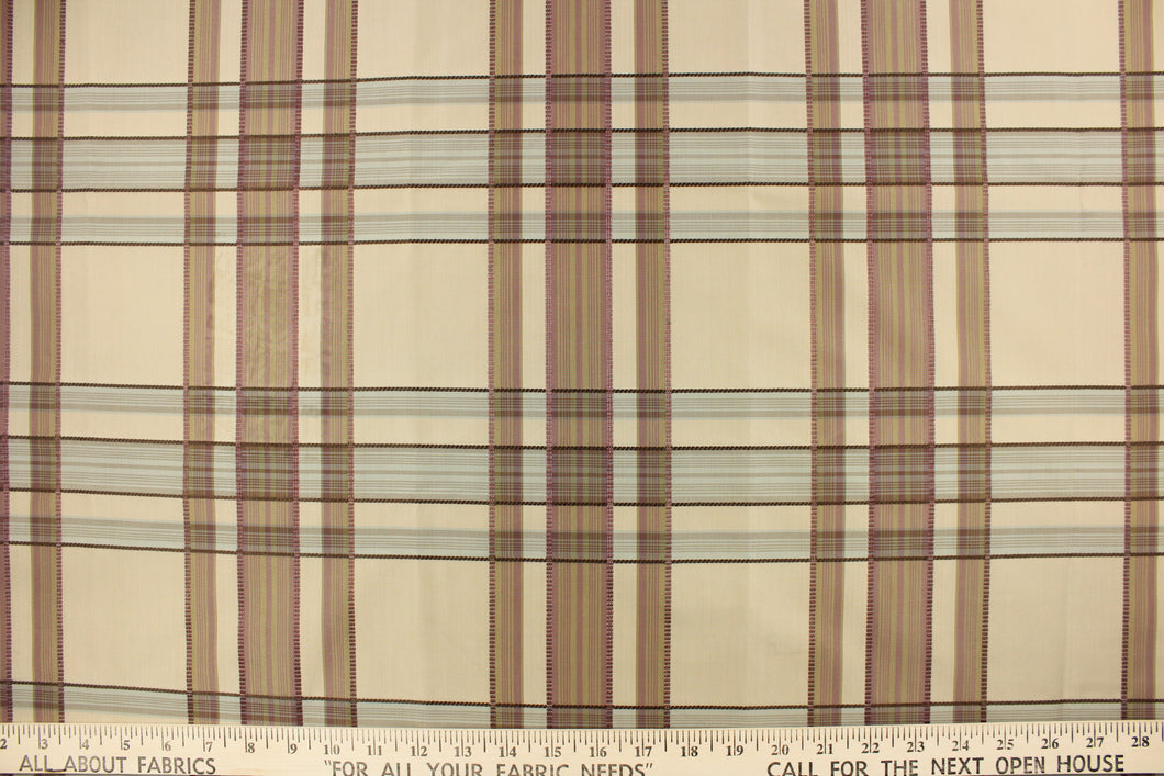 This fabric features a plaid design in mauve, pale blue and taupe. 