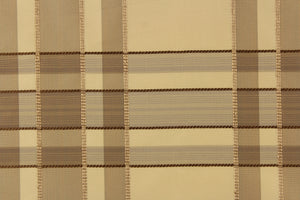 This fabric features a plaid design in beige, taupe, dark brown and gold.