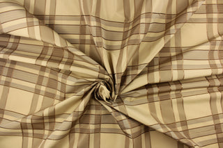 This fabric features a plaid design in beige, taupe, dark brown and gold.