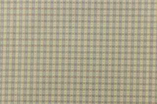 This yarn dye stripe fabric features a small plaid or checkered design in pale gray blue and beige.