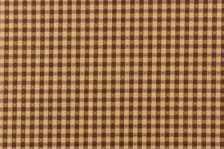  This yarn dye stripe fabric features a small plaid or checkered design in tan, brown and mauve.