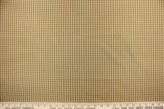 This yarn dye stripe fabric features a small plaid or checkered design in taupe, tan and brown.