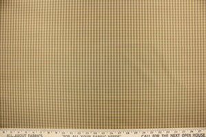 This yarn dye stripe fabric features a small plaid or checkered design in taupe, tan and brown.